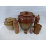 An assortment of stoneware storage jars and saltglazed flagons.