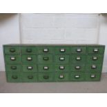 A stained pine bank of twenty-four drawers (tool drawers).