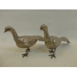 A pair of Indian silver peacocks, hallmarked to the tail feathers, five inches tall by eleven inches