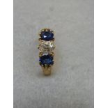 A fine 18ct gold old cut diamond and sapphire three stone ring, the diamond measuring 4mm x 5mm x