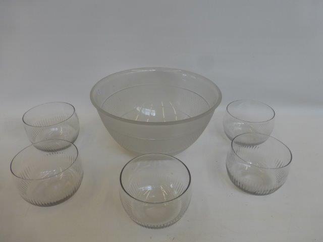 A large frosted cut glass bowl and a set of five glass bowls.