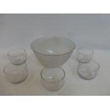 A large frosted cut glass bowl and a set of five glass bowls.
