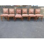 A set of six late Victorian light oak dining chairs with padded backs and over-stuffed seats, raised