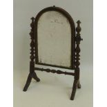 A Georgian inlaid mahogany oval topped dressing table mirror, raised on bobbin turned supports and