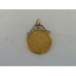 A Victorian 1878 Jubilee shield-back half sovereign in a 9ct gold mount.