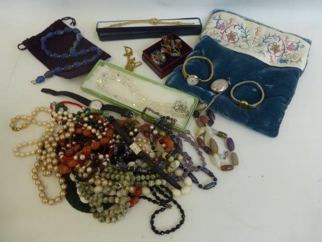 An assortment of costume jewellery including wristwatches etc.