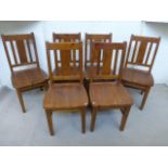 A set of six contemporary wooden dining chairs.