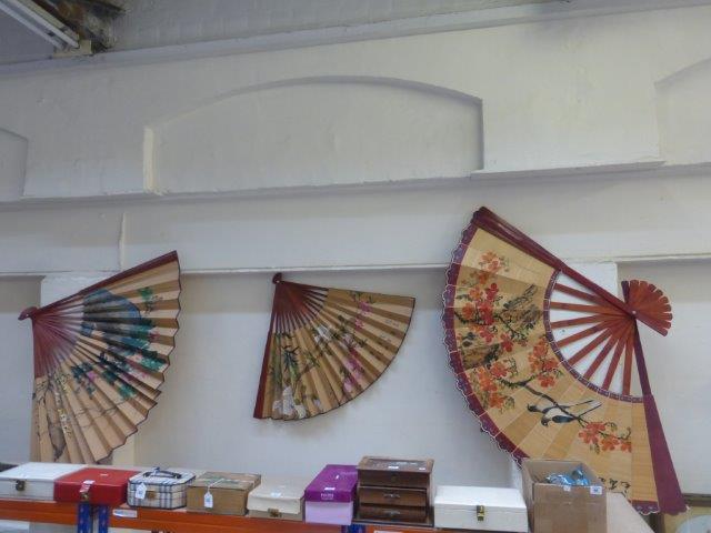 Three large wall covering fans.