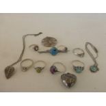 An assortment of silver jewellery including rings.