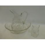 A glass three piece jug and bowl set.