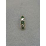An emerald and diamond five stone ring, centre stone A/F, size N/O.