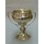 An Art Nouveau triple handled silver trophy with inscription "Cheltoz Cup" Presented by Mrs A
