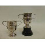 Two miniature twin handled trophies both with inscription B.B.W.E.P.A. Capalbio Cup 1 and Cup 2.