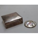 A silver cigarette box, maker - Kings and Sons, Chester, marks rubbed, and a circular silver