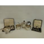 A silver three piece tea set comprising a teapot, milk jug and a twin handled sugar bowl, maker