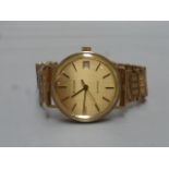 A 9ct gold Bulova Quartz gent's wristwatch with 9ct gold strap.