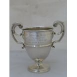 A twin handled silver trophy with inscription "The Carnival Music Cup" presented by Miss Chenuz