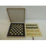 A cased marble chess set with board.