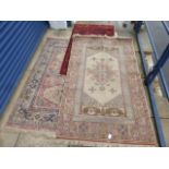 Three assorted floor rugs, two of Eastern style with central medallions, and a handmade silk Eastern