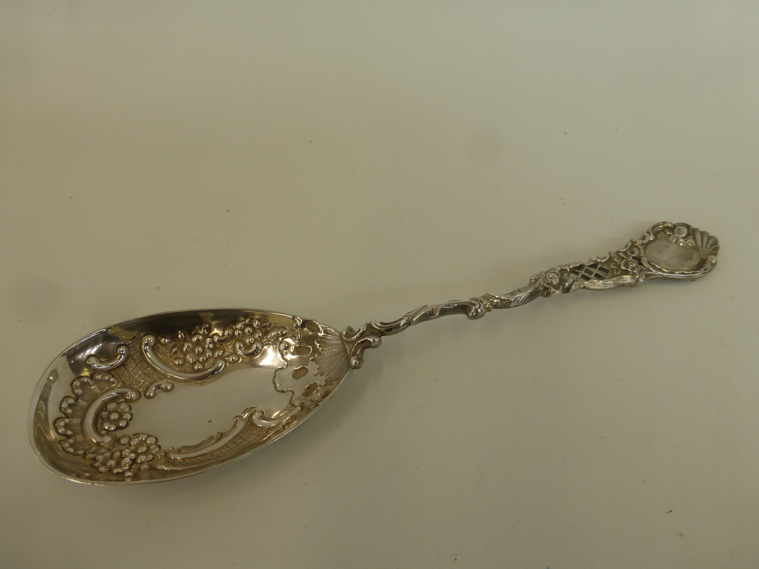 A Victorian silver spoon with embossed and pierced decoration, maker's mark rubbed, London, 1897.