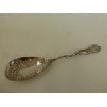 A Victorian silver spoon with embossed and pierced decoration, maker's mark rubbed, London, 1897.