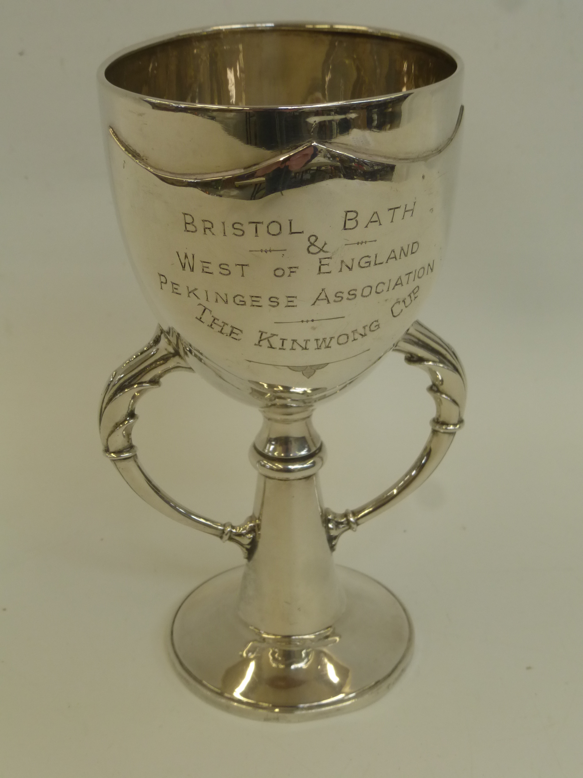 A twin handled silver trophy with inscription Bristol, Bath and West of England Pekingese