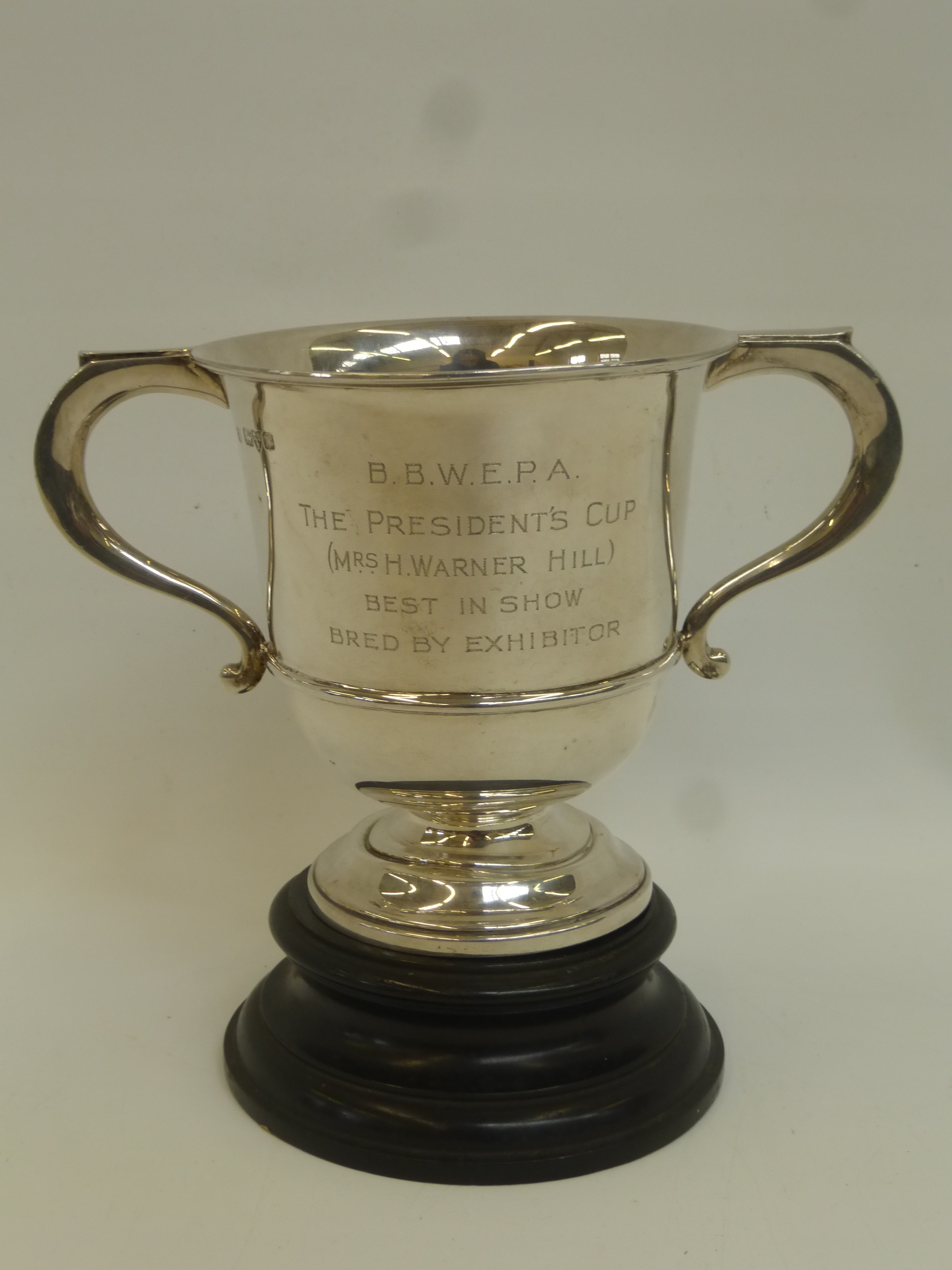 A twin handled silver trophy with ebonised stand with inscription B.B.W.E.P.A. "The Presidents