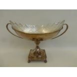 A large silver plated twin handled Neo Classical table centre piece with glass liner.