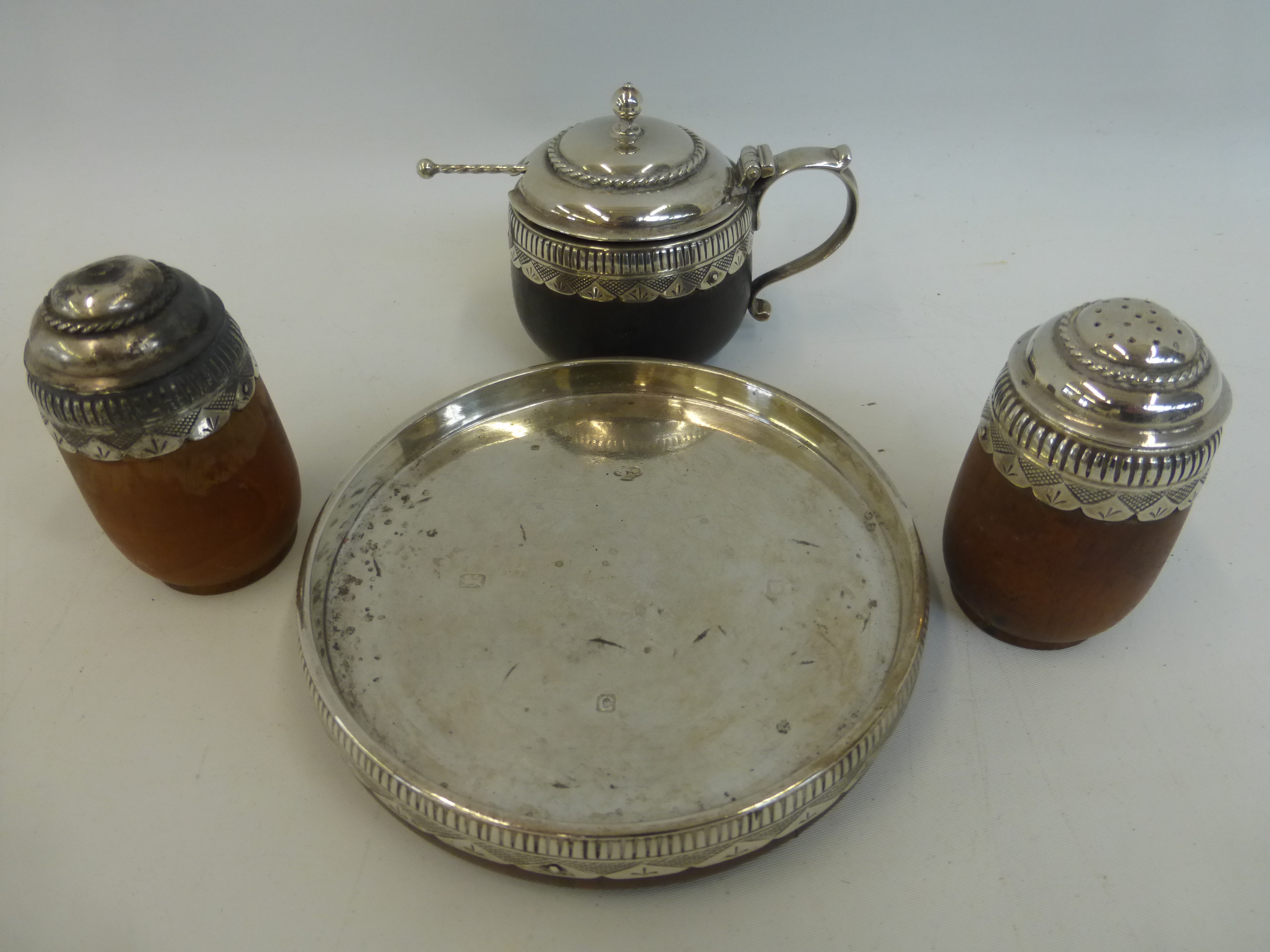 A four piece silver mounted wooden condiment set, maker - John Charles Lowe, London 1938.