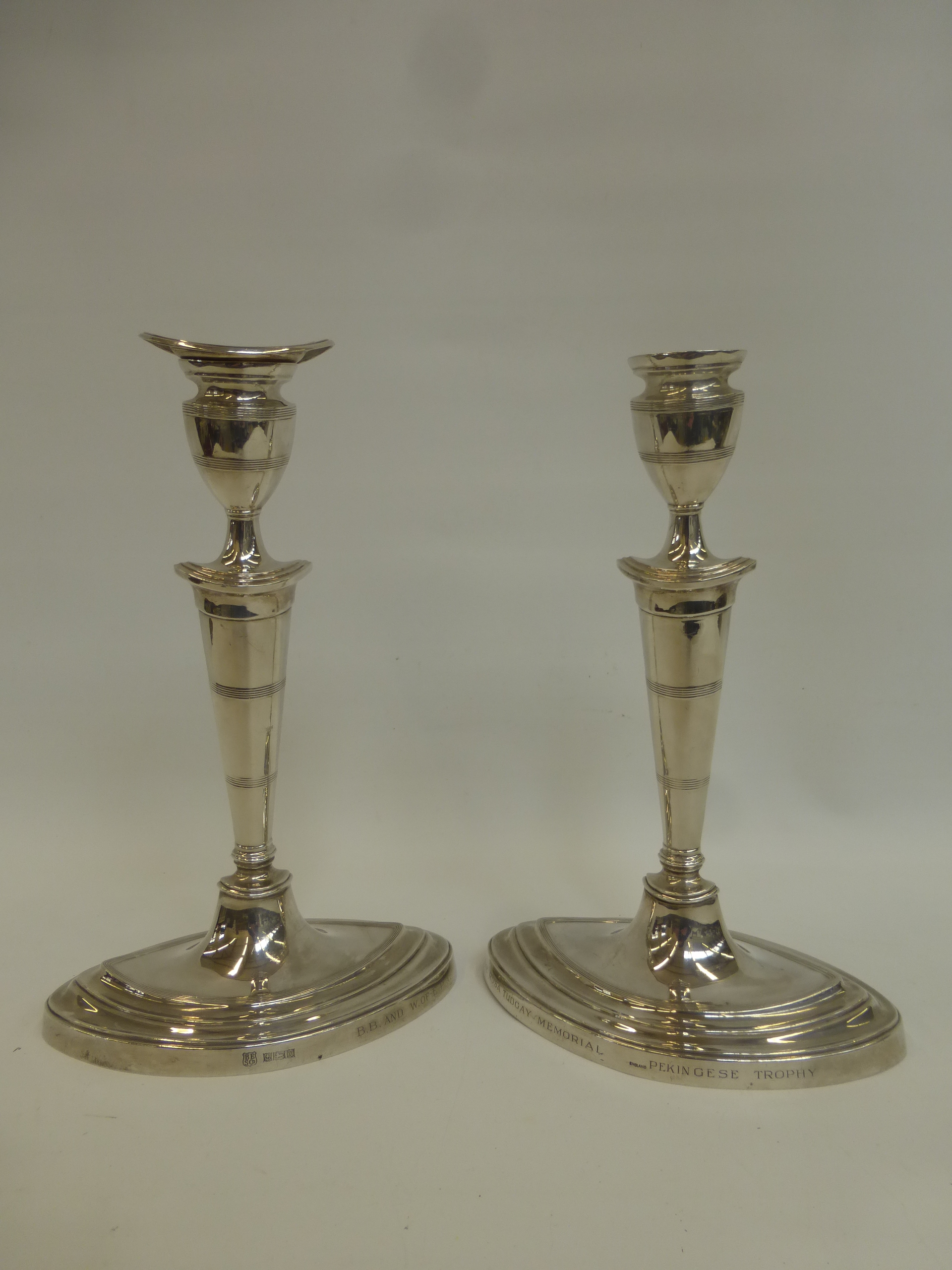 A pair of Regency style silver candlesticks with inscription B.B and W. of E.P.A. "The Rosa Tudgay