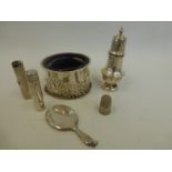 An assortment of silver including lidded pin holders, a miniature mirror, a pepper shaker, a thimble