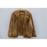 A light tan fur jacket.