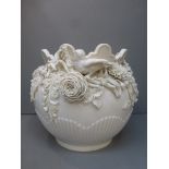 A Belleek ceramic jardiniere decorated with applied garlands of flowers, birds and foliage, second