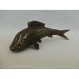 A bronzed cast metal figure of a koi carp.