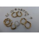 An assortment of faux diamond and 9ct gold earrings, and three pairs of 9ct gold hooped earrings,