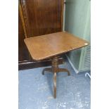 A Victorian mahogany rectangular tilt top occasional table raised on three shaped supports.