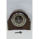 An Art Deco wooden cased mantel clock, Made in England stamped to the case with Westminster chimes