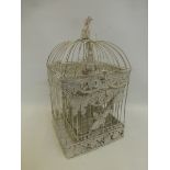 Three Victorian style graduated metal bird cages.