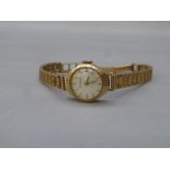 A Freeson seventeen jewels 9ct gold lady's wristwatch with a 9ct gold strap, weight 15.7g.