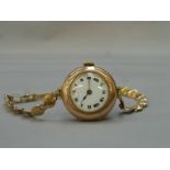 A 9ct gold Rolex lady's wristwatch with 9ct gold strap, circa 1930s.
