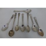 An assortment of silver teaspoons.