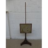 A Victorian rosewood pole screen with needlework glazed screen.