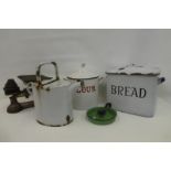 An assortment of enamelled kitchenalia comprising a flour and bread bin, chamber stick, watering can