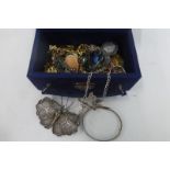 A box of assorted costume jewellery including a silver bangle, a silver butterfly brooch etc.