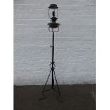 An Arts and Crafts wrought iron and copper mounted oil lamp standard, converted for electrical use.