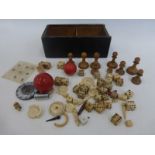 A box of assorted ivory, boxwood and bone gaming pieces.