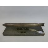 A miniature WWII torpedo mounted on a marble base with applied plaque inscribed KIEL, possibly