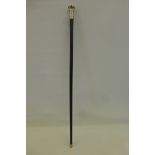 An ebonised walking cane with a large silver knop with engine turned decoration, maker's mark