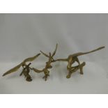 Five assorted brass birds of prey of various sizes.