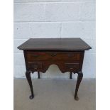 An 18th Century oak lowboy with moulded top and inverted corners, with one long drawer aboove two